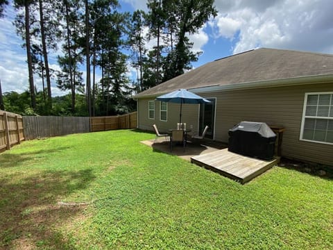 Fenced back yard with patio furniture, grill, & fire pit