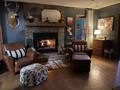 Upstairs living room with fireplace and walk-out access to upper deck