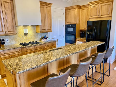 If you love to cook, this kitchen is fully stocked -- and the island seats four.