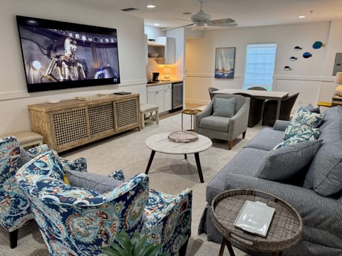Watch the big game, or the big movie, on the 85" screen in the poolside den.
