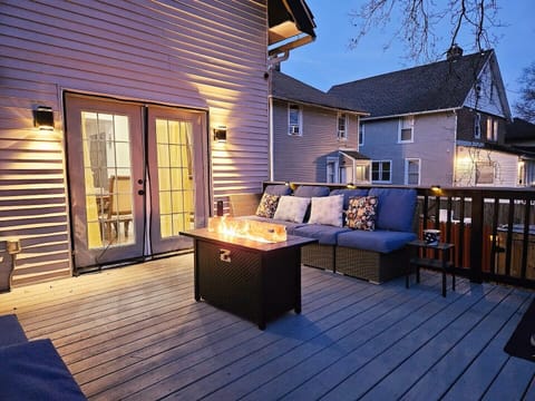 Spacious deck with outdoor propane fire pit and comfy seating.