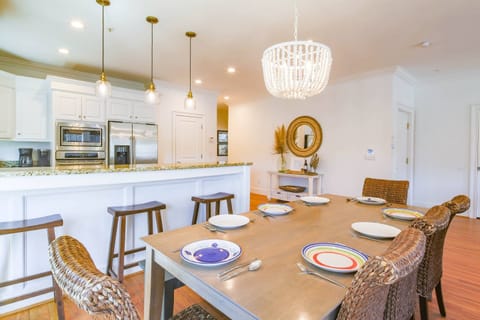 The dining table seats 8 and there are 3 stools at the kitchen counter.