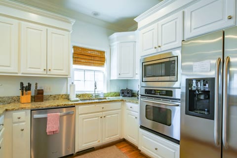 There is a dishwasher, oven, refrigerator, microwave and toaster.