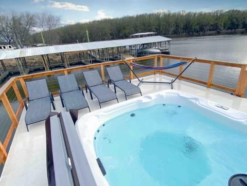 rooftop deck with a hot tub