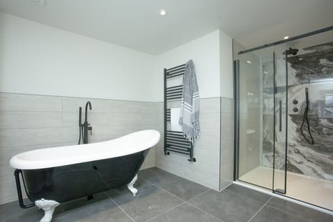 Freestanding bath with heated towel rail and walk in shower - Pilgrim Suite