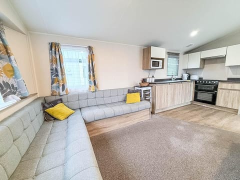 The living area in the caravan is perfect for hosting family dinners or enjoying quiet evenings.