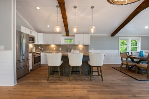 Fully equipped kitchen with breakfast bar, seating for 3