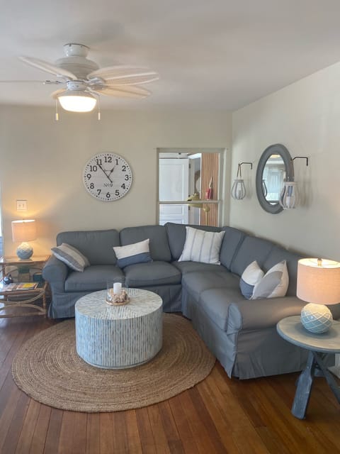 New sectional sofa surrounded by new accent tables, lamps and ceiling fan/light.