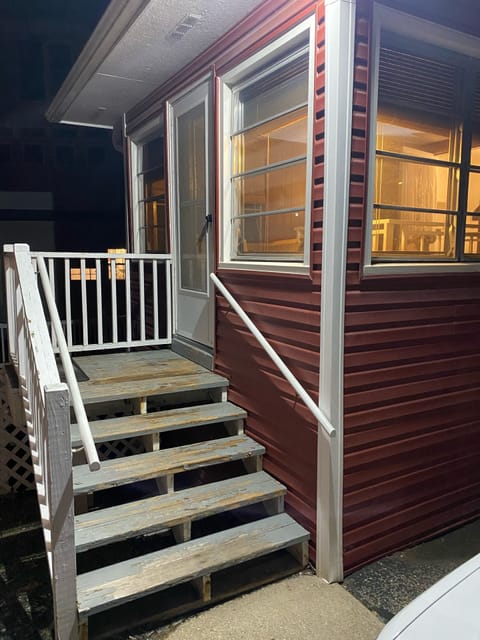 Rear entry porch with daybed and storage area.