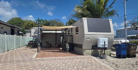 recently painted and updated with covered porch, patio furniture,  and sunsails