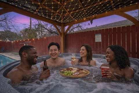 Relax in the hot tub under cozy lights after a fun day.