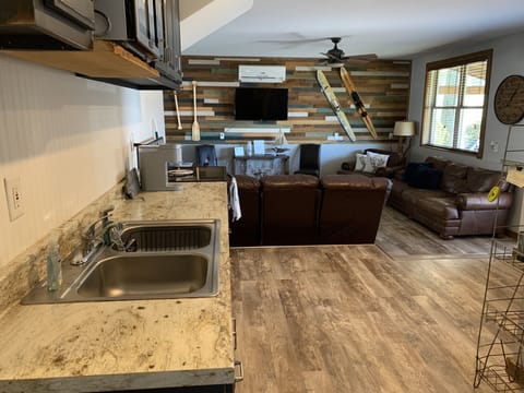 As you enter the cabin, the kitchen is first and then the living area.