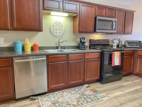 Kitchen with dishwasher, full oven, microwave, and toaster oven