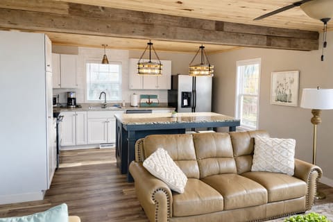 The updated kitchen features eye catching modern lighting and a clean, stylish design, ideal for cooking and prepping while staying connected with your group. Share conversations, make meals together, and catch glimpses of the view as you cook