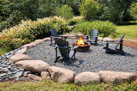 As the day winds down, the fire pit becomes the gathering place. Set within clean, stone landscaping, it feels modern, intentional, and quietly inviting. Let the crackle take over, and sink into the moment stories, laughter, and tired legs finally at rest.