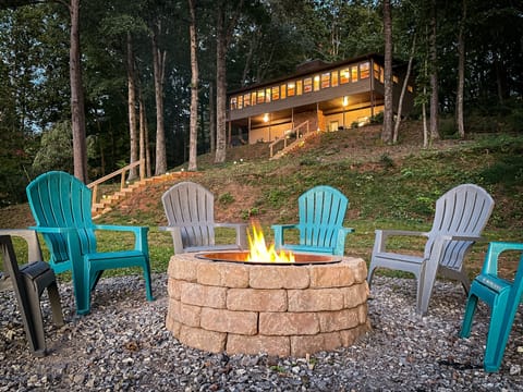Windows in the sunroom overlook the lake, fire pit, and gorgeous mountain views.