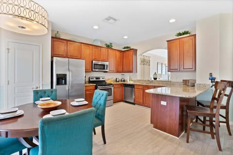 Spacious kitchen with granite countertops, stainless steel appliances, and a breakfast nook.