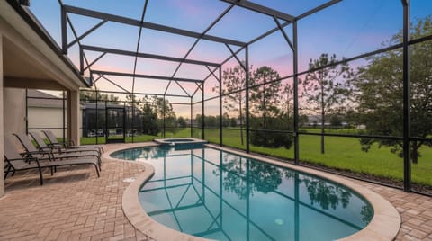 Relax in the screened private pool and spa with tranquil views of the greenbelt.
