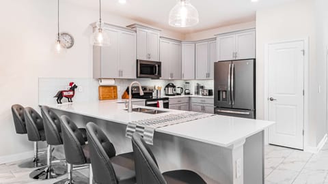 Start your day in style at the sleek breakfast bar, a chic and casual space that adds a touch of modern elegance to your morning routine.