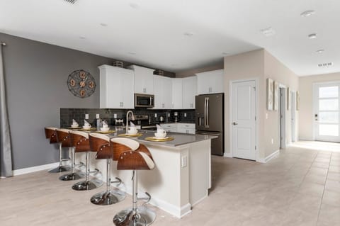 Enjoy the convenience of a second kitchen area with additional counter space, modern cabinetry, and double ovens. Ideal for large groups, this space provides all the amenities needed to cater to everyone's dining preferences.