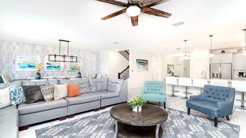 Spacious open-concept living with designer seating, modern kitchen, and style