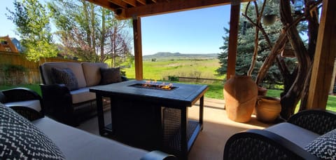 Covered patio, rocking couches & chairs,fire feature, retracting privacy screen.