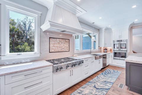 Fully stocked kitchen with stainless steel appliances.