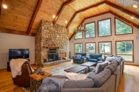 Huge great room with soaring wood ceilings and heavy timbers, stone wood burning fireplace and abundant seating