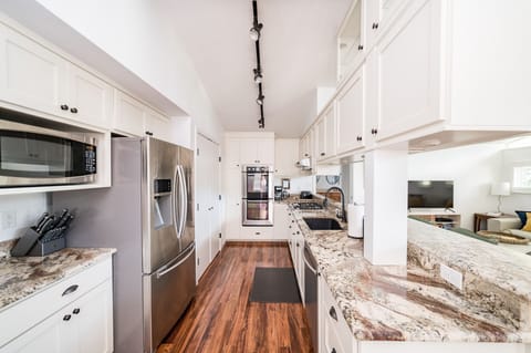 Stocked kitchen w/ stainless appliances, granite countertops, pots/pans, etc.