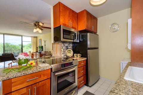 Kitchen/living room view.  Kitchen Aid glass top stove, built in microwave.