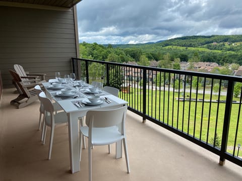 Terrace, featuring a dining table with room for six, and two Adirondack chairs