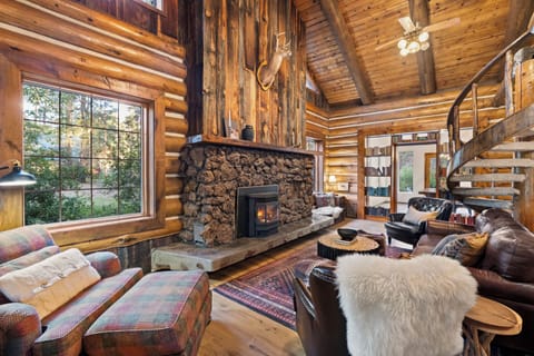 Large cozy living room with soaring ceilings and windows out to the aspens