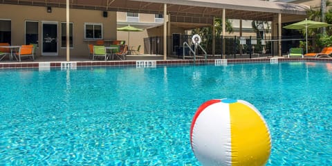 Soak up the afternoon with playful poolside vibes and seating.