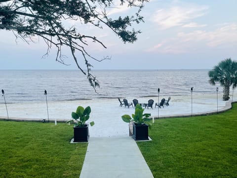 Professionally landscaped lawn leading onto your private 144 ft. beach. 