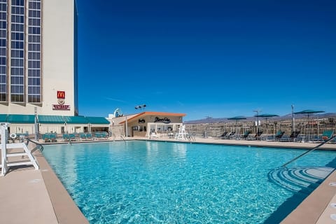 Dive into sparkling pool waters and lounge under desert sun.