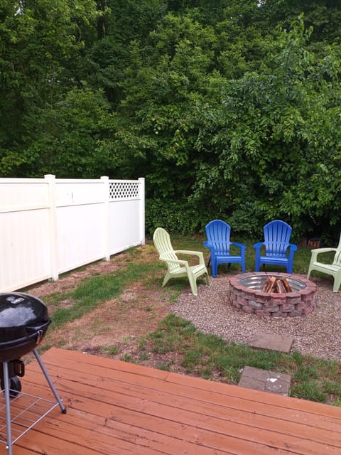 small backyard and fire pit. still a work in progress. charcoal grill and table