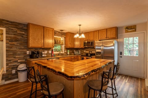 Updated kitchen with stainless appliances and live edge island with 4 barstools