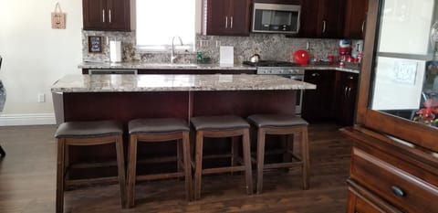 Granite Island with 4 bar stools for additional seating