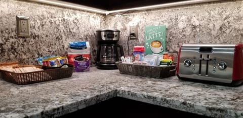 Breakfast station contains coffee, tea, hot cocoa, creamer and sugars.