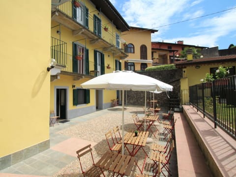 Building, Plant, Window, Property, Flowerpot, Umbrella, Shade, Houseplant, Lighting, Outdoor Furniture
