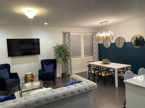 Open living/dinning area with 70” TV- 6-8 table seating plus 3 bar seats 