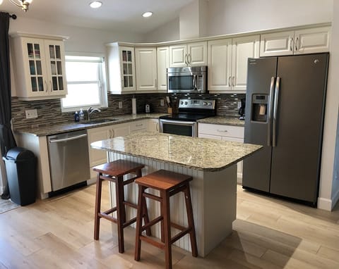 Features stainless steel appliances and granite countertops.