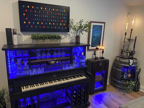 Custom built piano bar, musical lamps, and a barrel bar-where old meets new.   