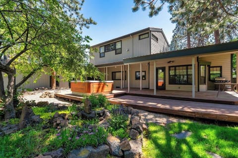 Private backyard with hot tub, rock herb garden, BBQ, outdoor dining tables and chairs.