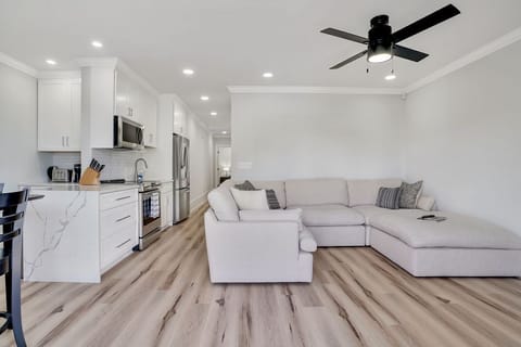 Living room, dining table and kitchen. (view 1)