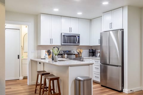 Newly renovated kitchen w/ solid stone countertops.