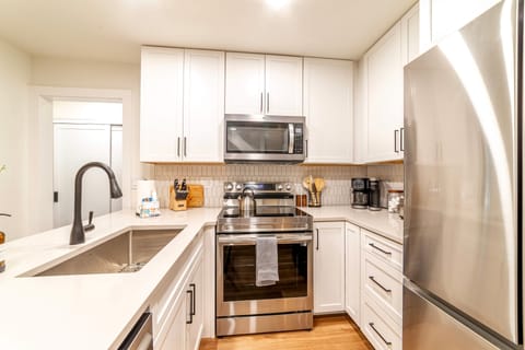 Kitchen comes fully stocked w/ new stainless steel appliances.