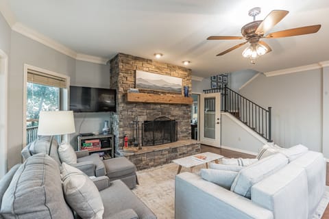 Main living room-plush swivel chairs, TV/fireplace/games & makes into QU bed