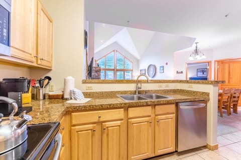 Full sized kitchen with granite countertops and stainless steel appliances.