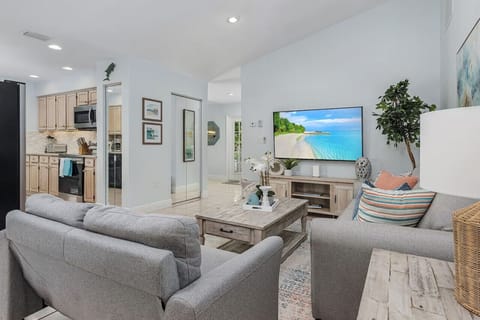 Second living area with 65" smart TV and queen size sofa bed.